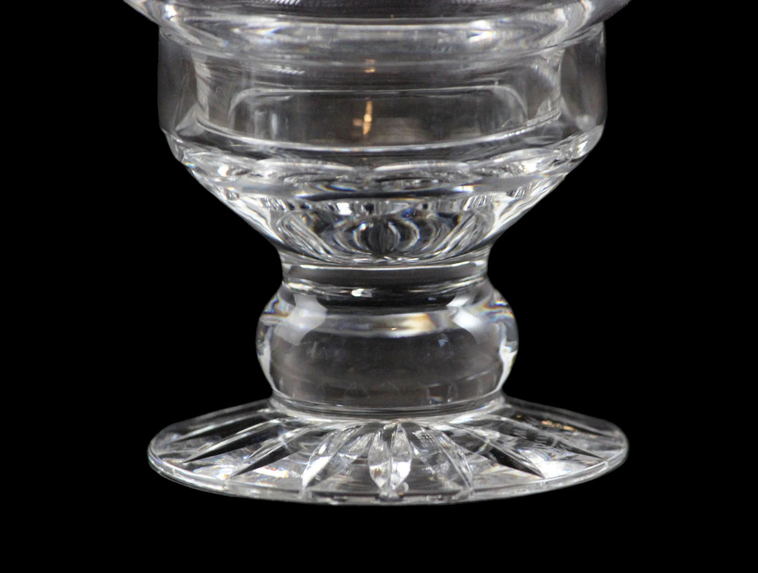 Clear glass candle holder on a black background