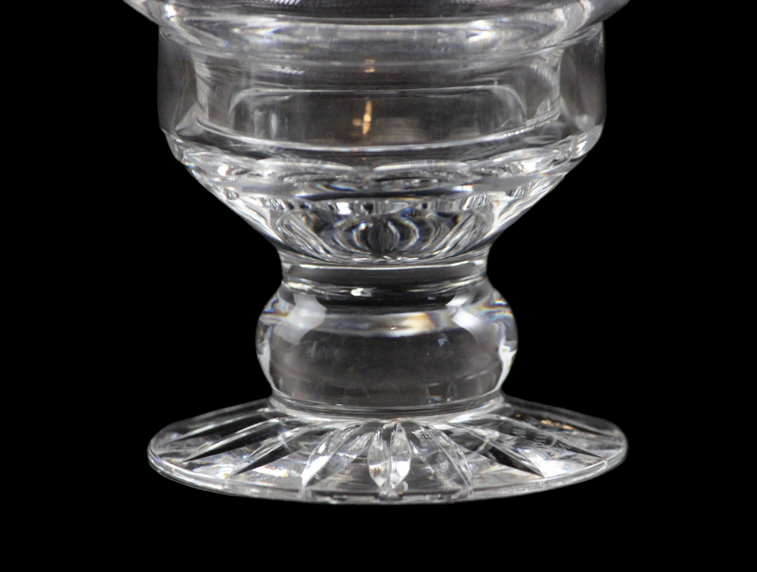 Clear glass candle holder on a black background