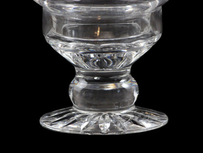 Clear glass candle holder on a black background