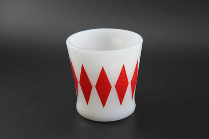 A second white glass coffee mug with a red harlequin diamond pattern, set against a dark gray background.