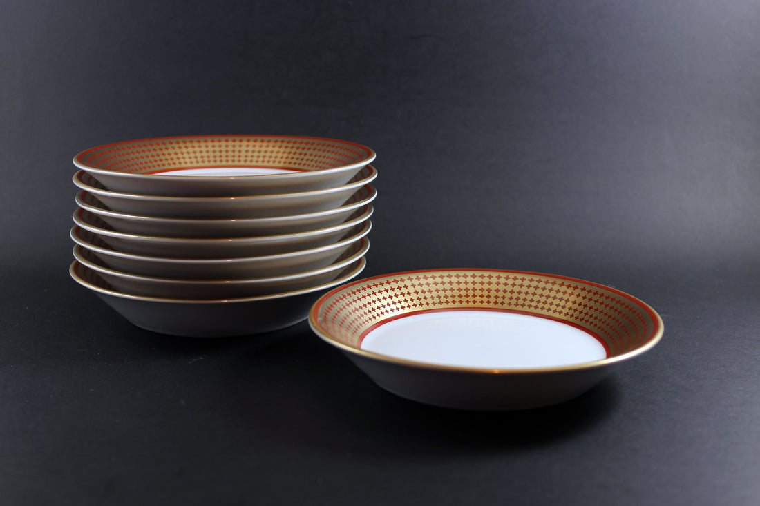 Set of ceramic bowls with decorative rim on a dark background