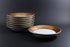 Set of ceramic bowls with decorative rim on a dark background