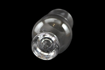 Clear glass whiskey glass on a black background