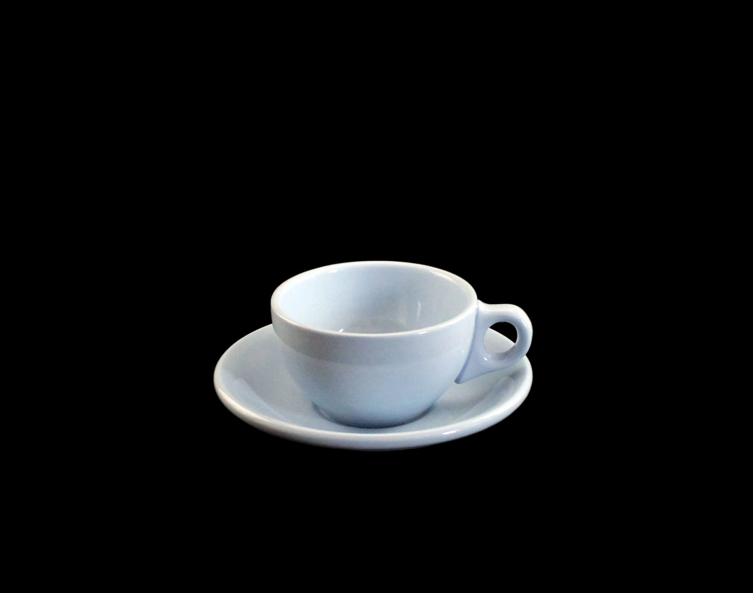 Light blue ceramic cup and saucer on a dark background
