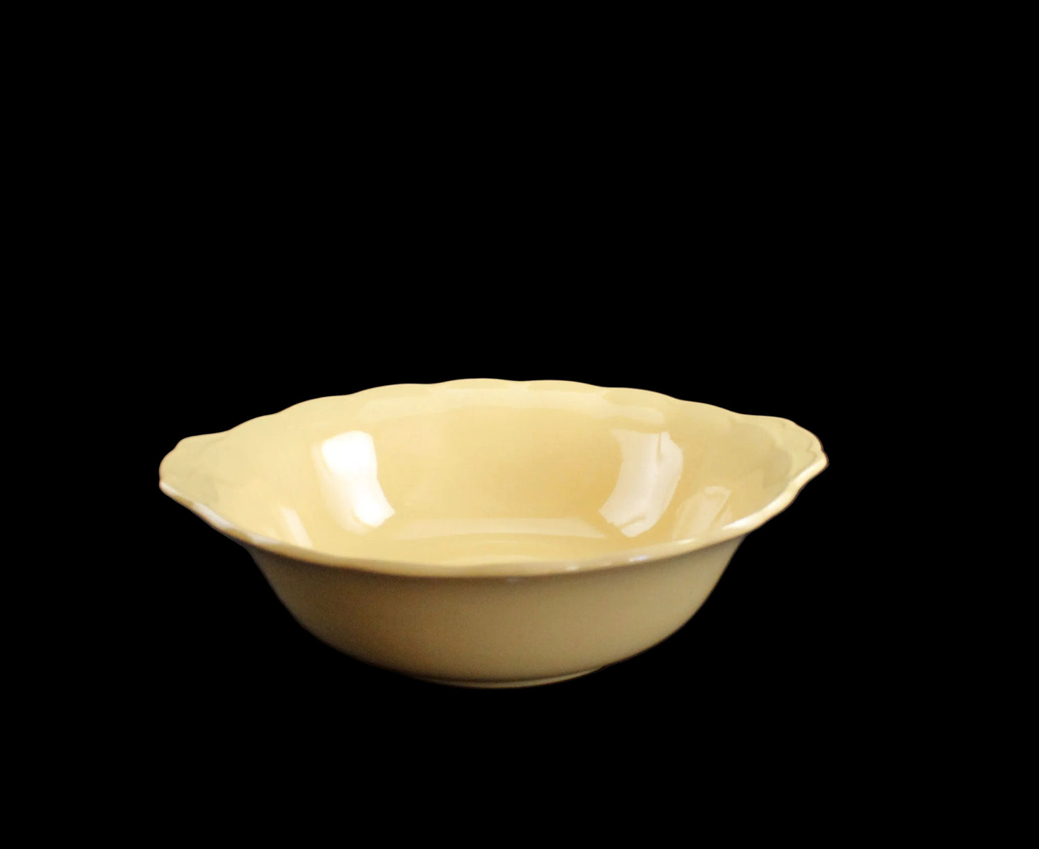 Yellow ceramic bowl on a black background