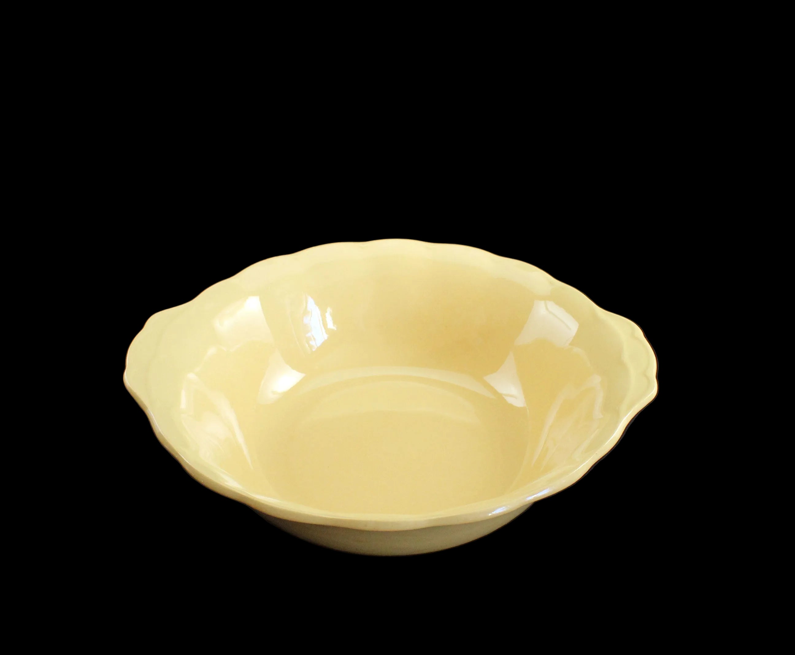 Yellow ceramic serving bowl on a black background
