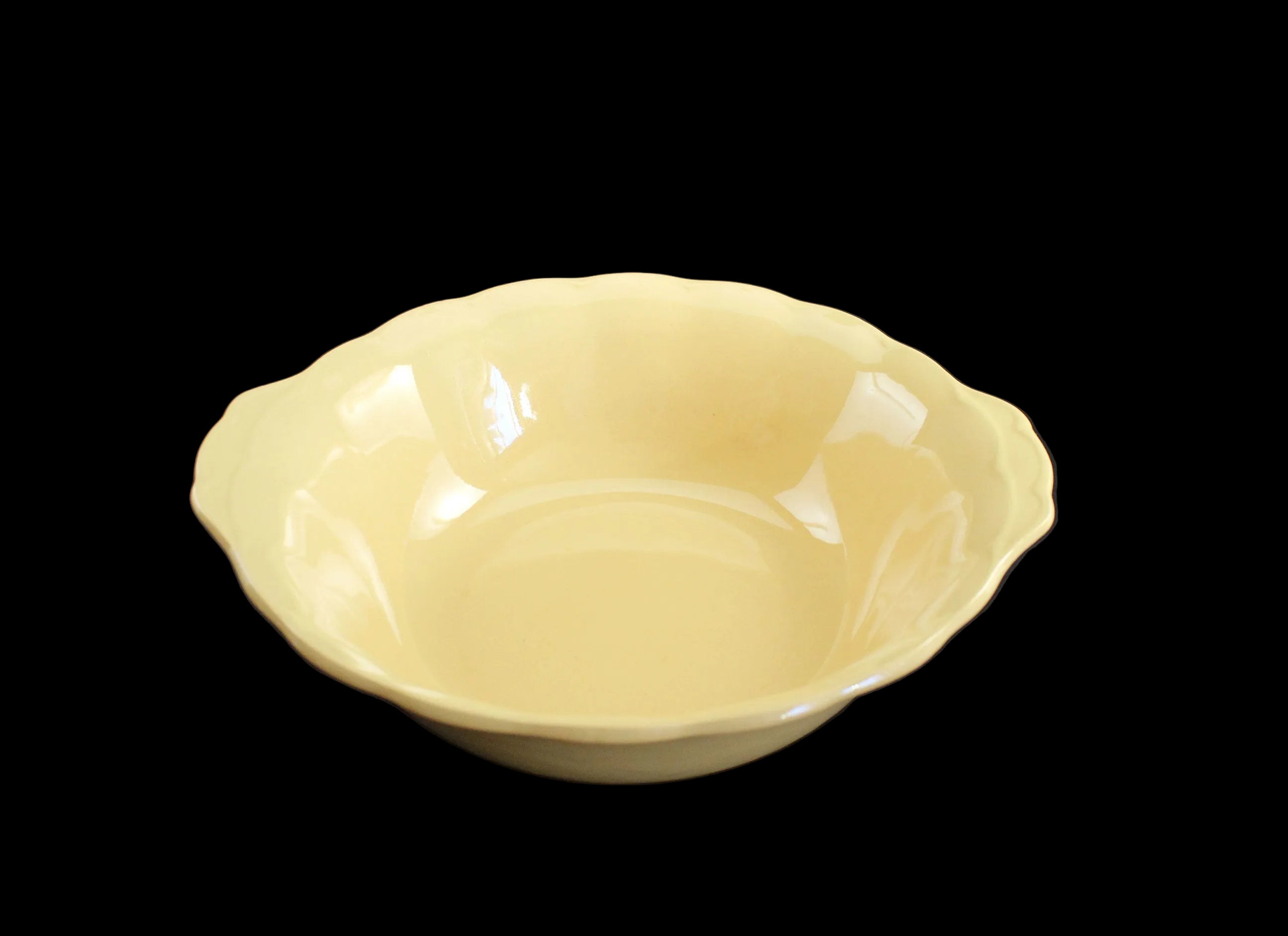 Yellow ceramic bowl on a black background