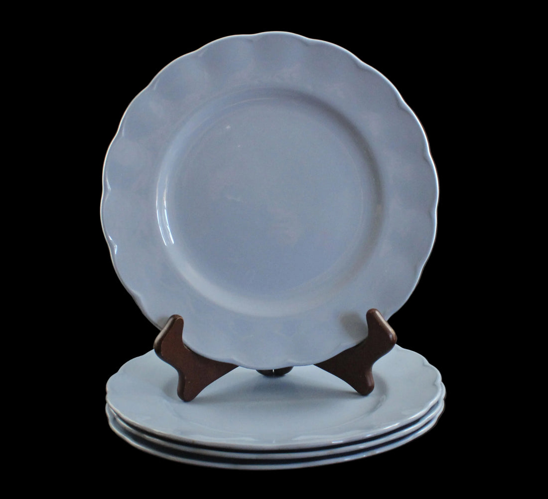 Set of light blue ceramic plates on a black background