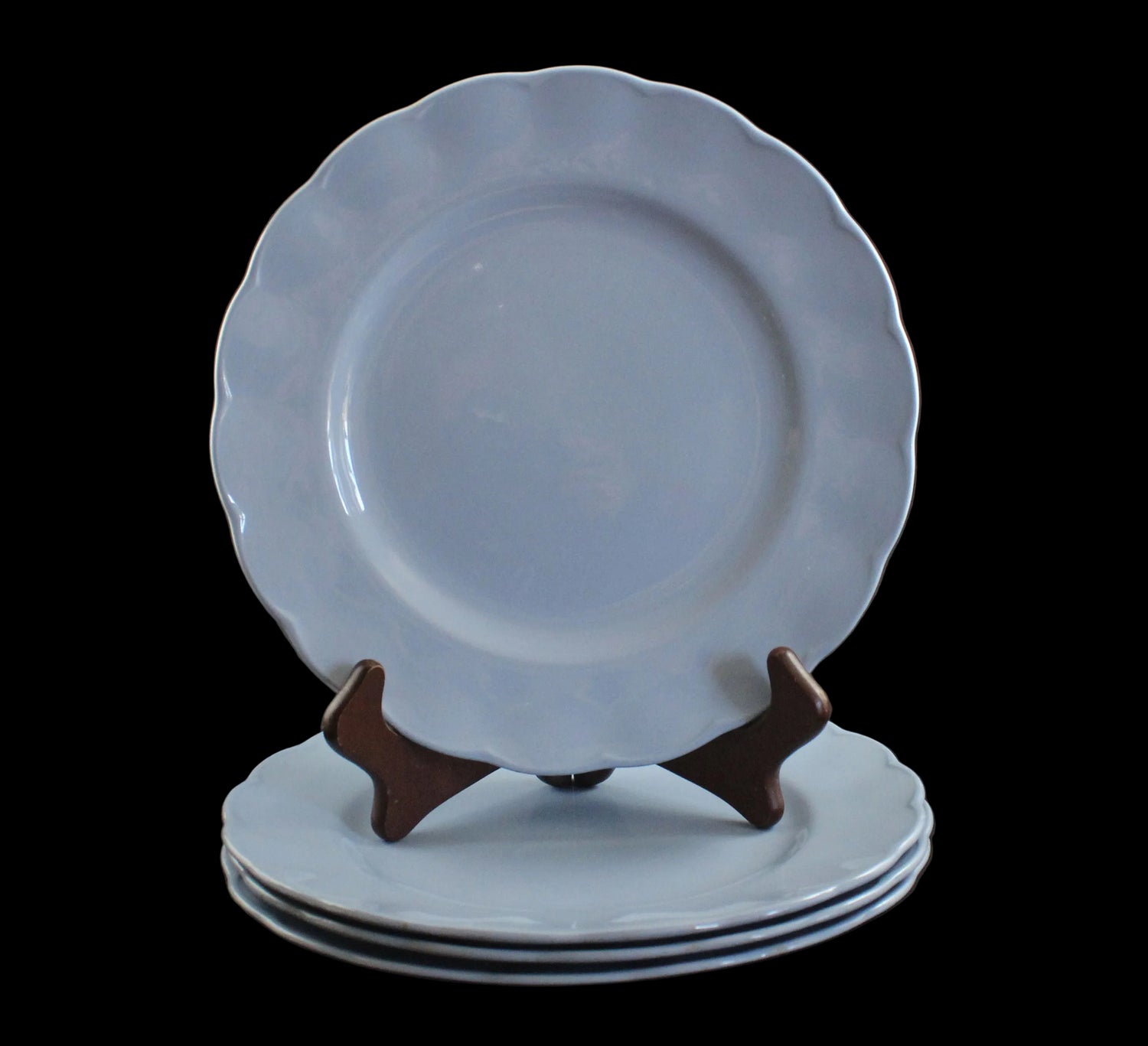 Set of light blue ceramic plates on a black background