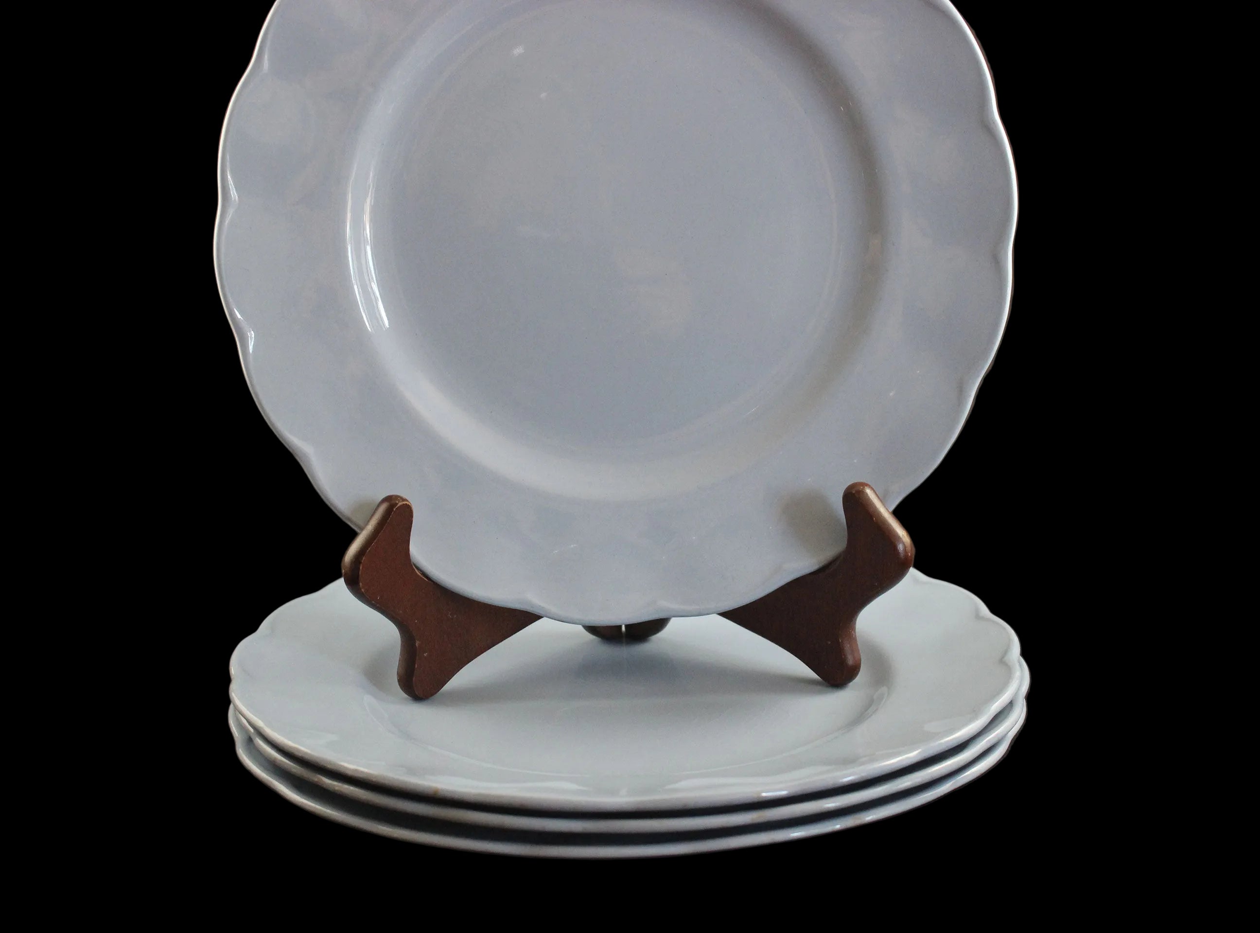 Set of light blue ceramic plates on a black background