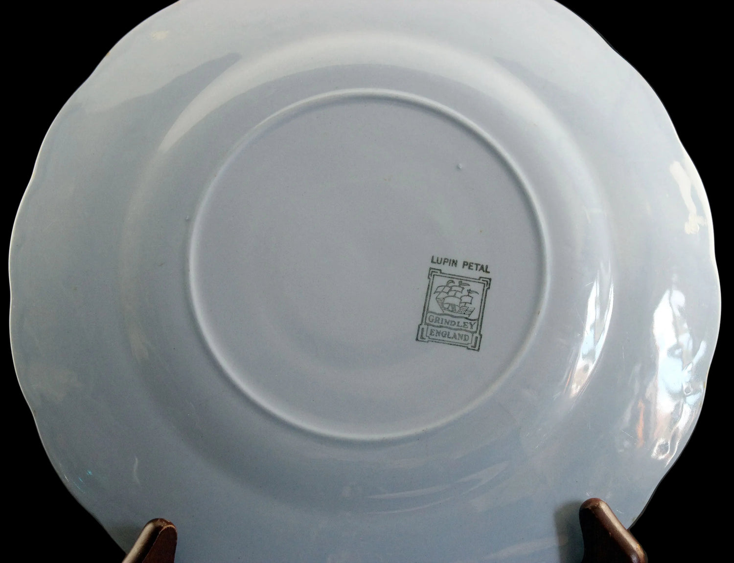 Set of light blue ceramic plates on a black background
