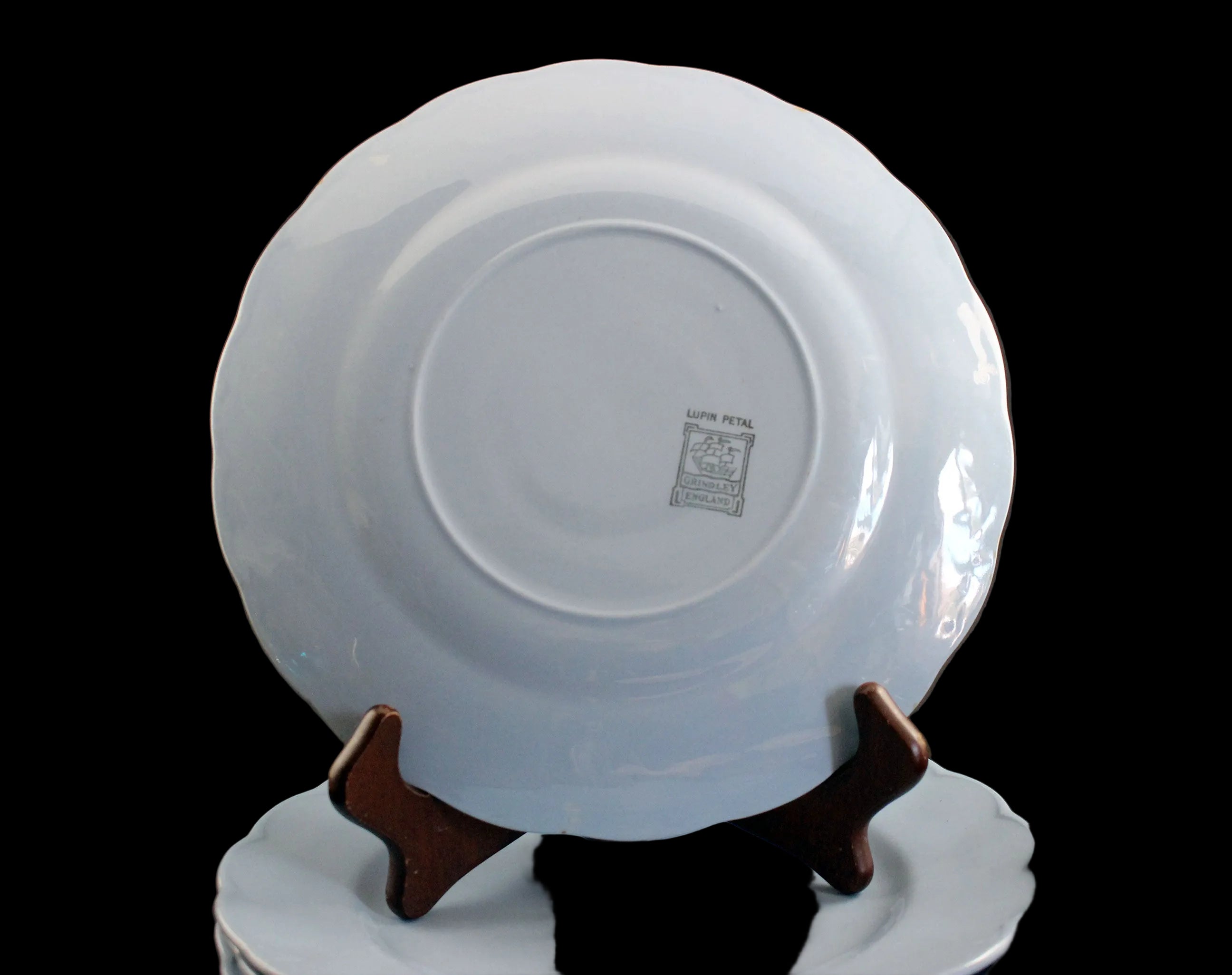 Set of light blue ceramic plates on a black background
