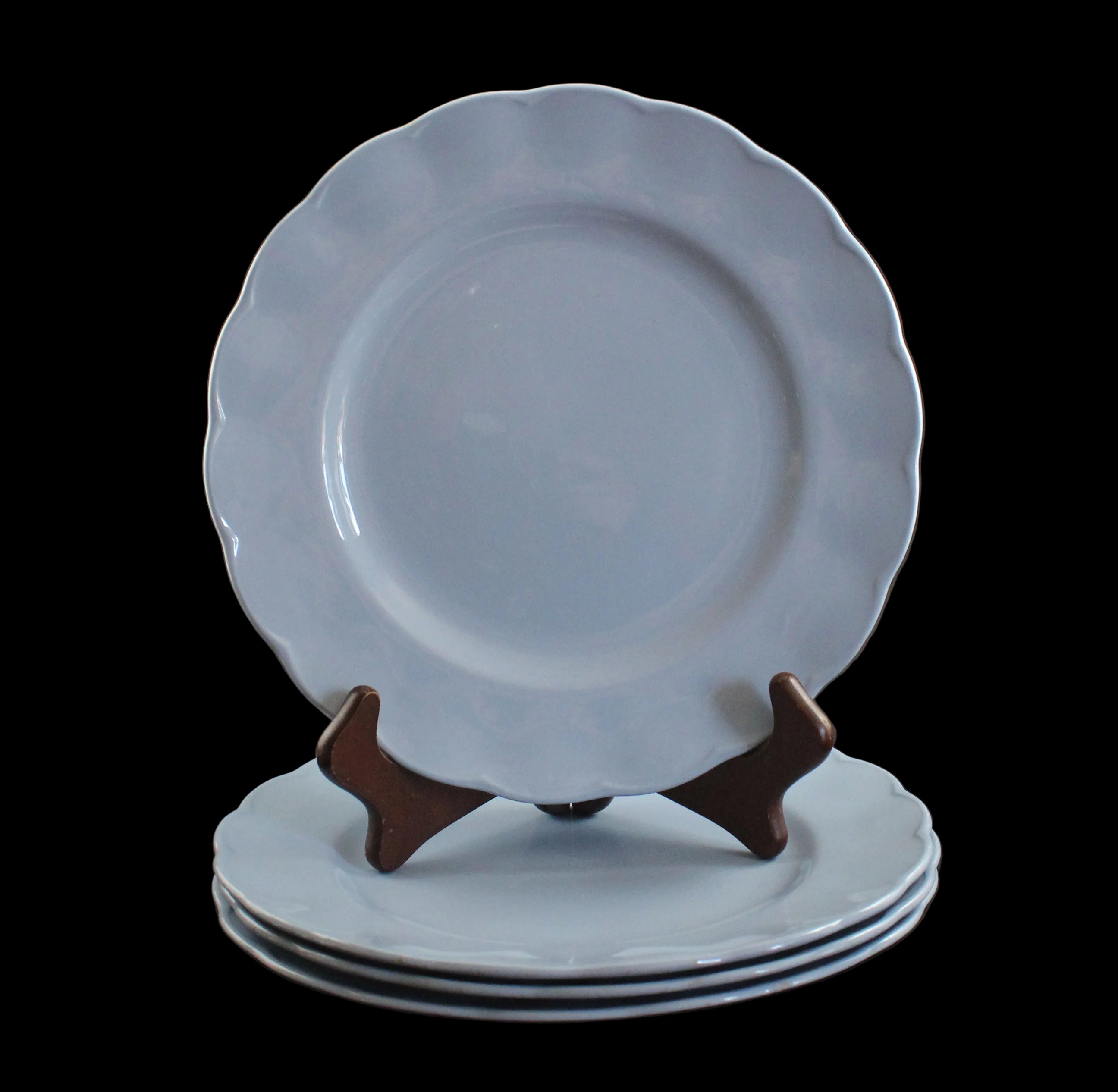 Set of light blue ceramic plates on a black background