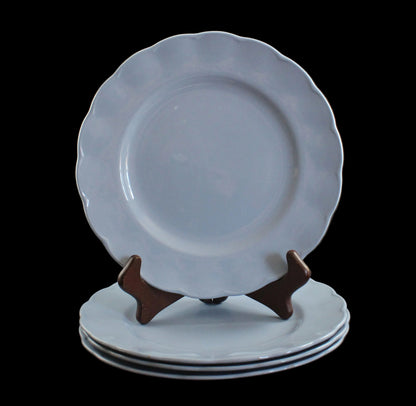 Set of light blue ceramic plates on a black background