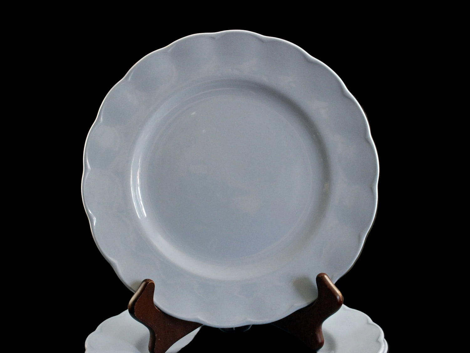 Set of light blue ceramic plates on a black background