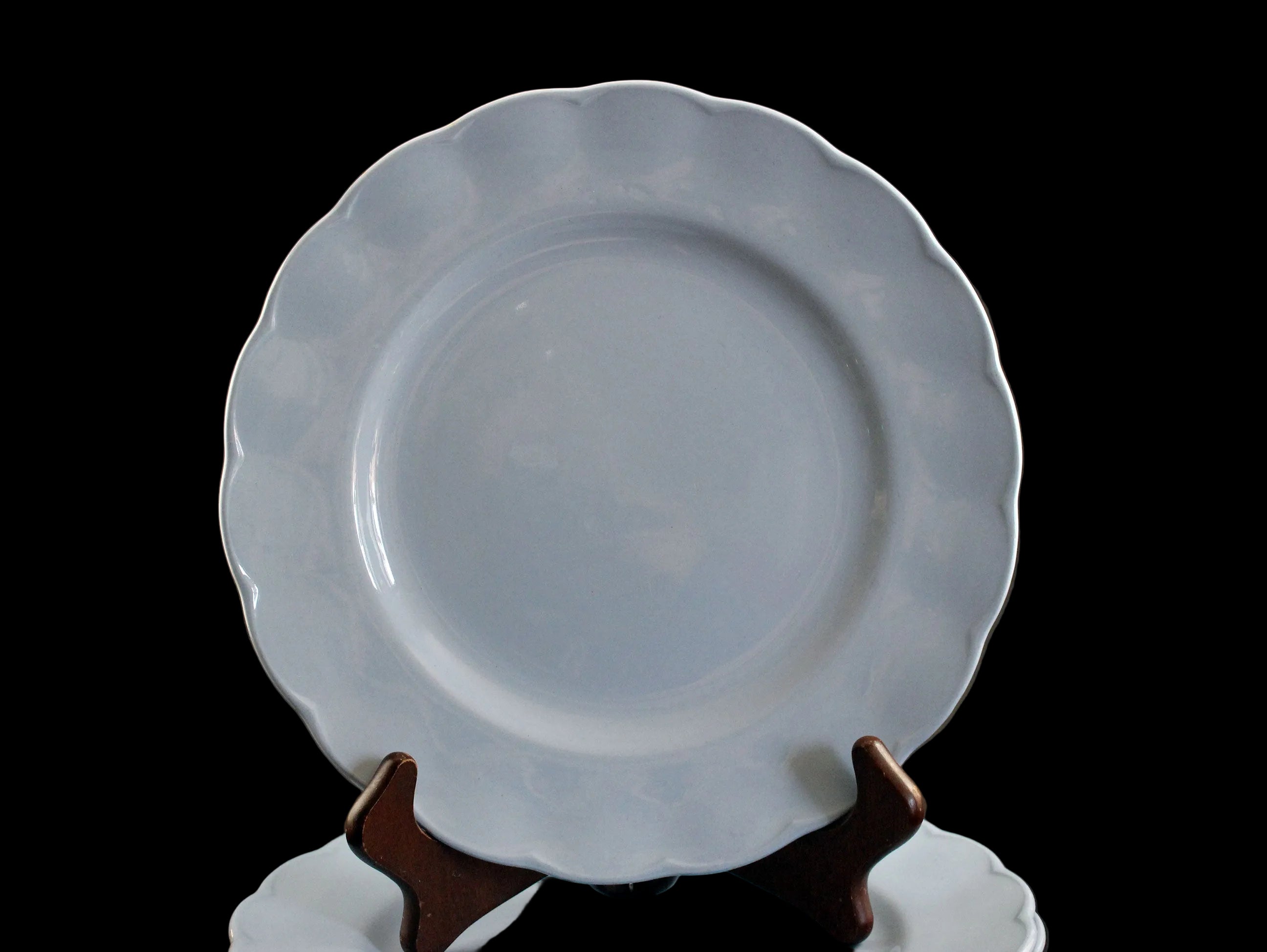 Set of light blue ceramic plates on a black background