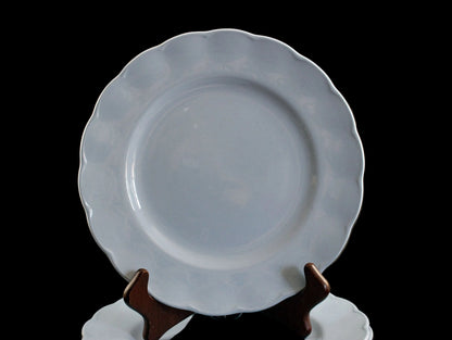 Set of light blue ceramic plates on a black background