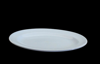 A blue ceramic oval serving platter with a shallow center, shown on a dark gray background.