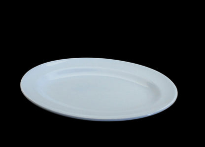 A light blue ceramic oval serving platter on a dark gray background.