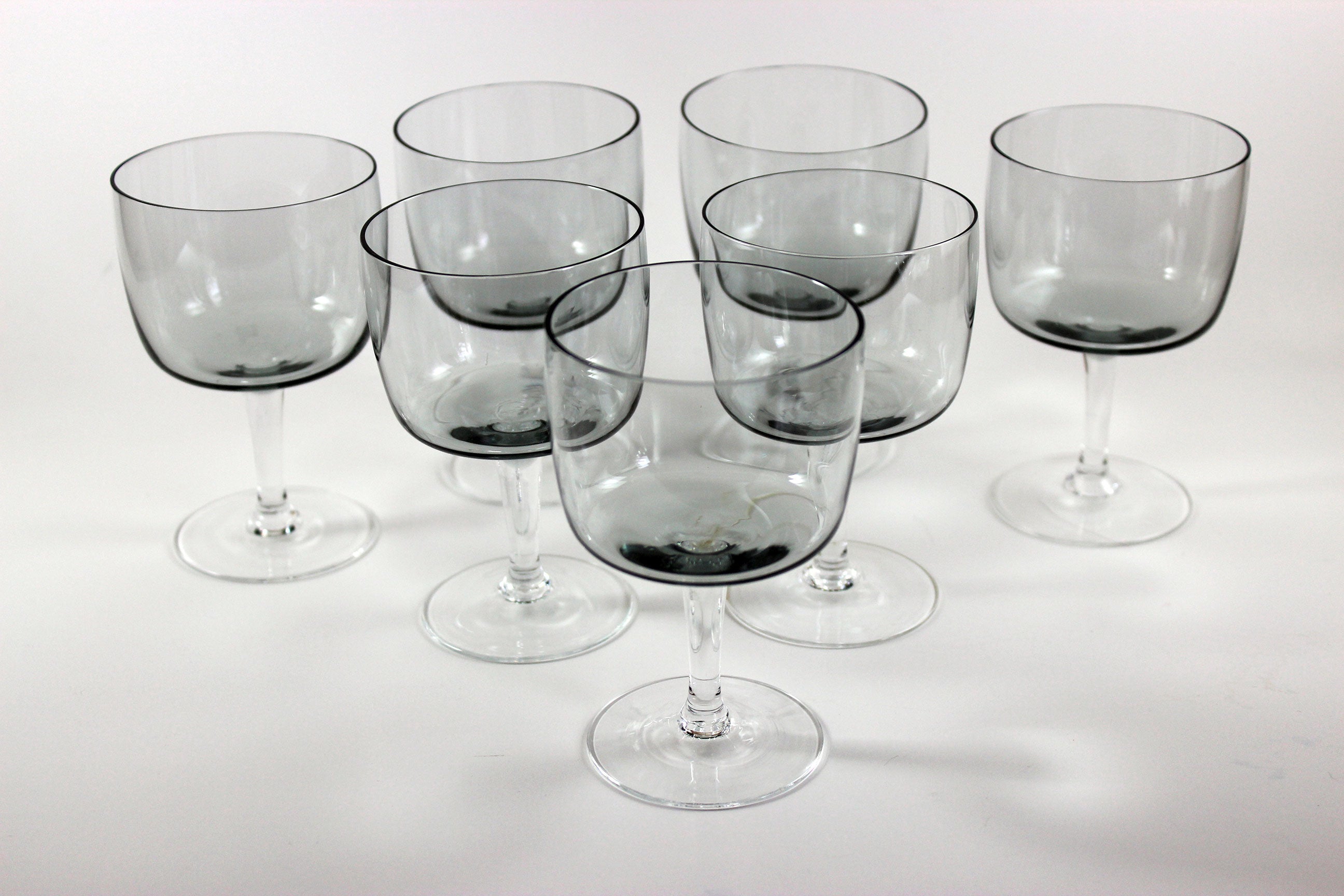 Set of smoked glass port glasses on a white background