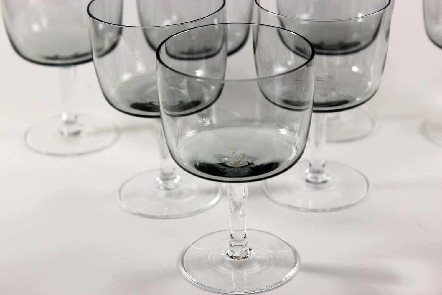 Set of smoked glass port glasses on a white background