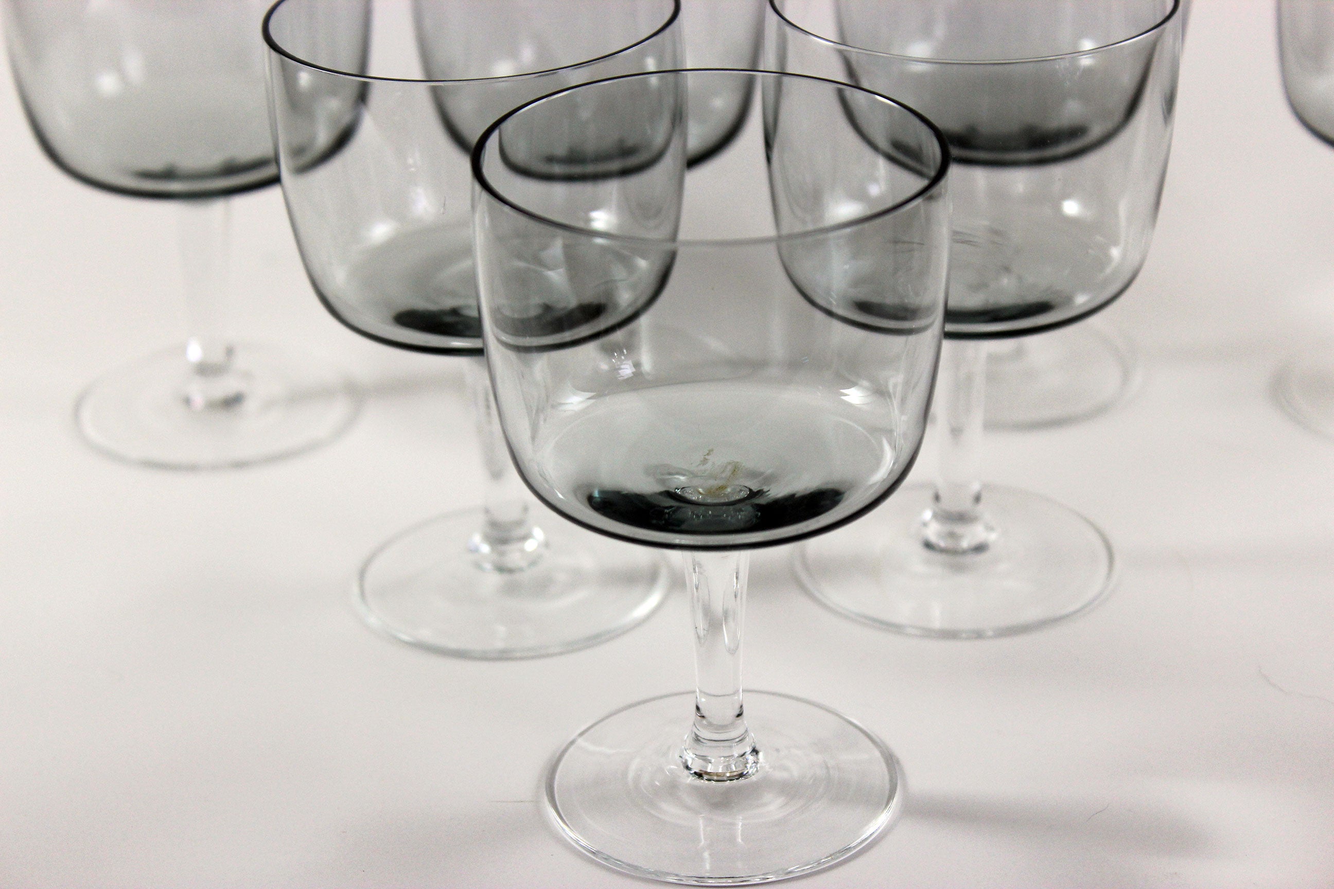 Set of smoked glass port glasses on a white background