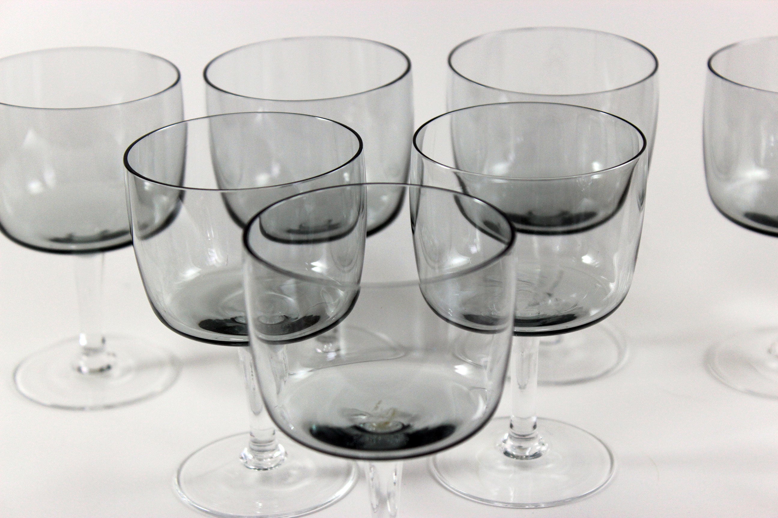 Set of smoked glass port glasses on a white background