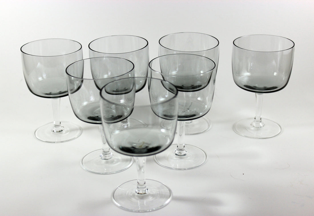 Set of smoked glass wine glasses on a white background