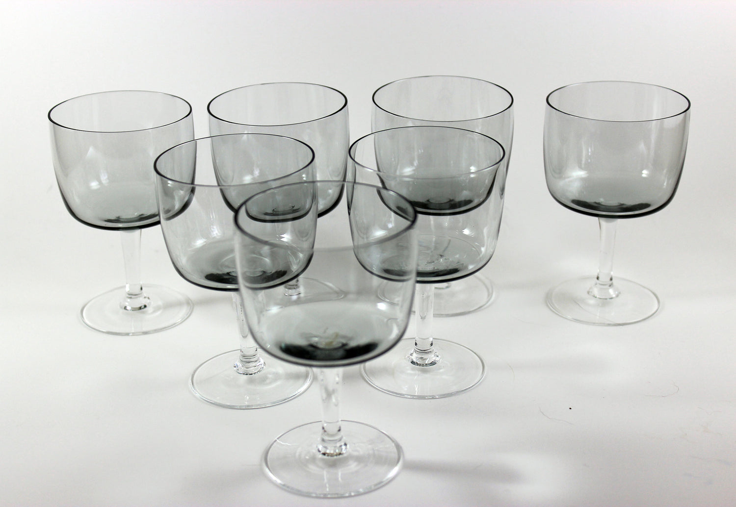 Set of smoked glass wine glasses on a white background