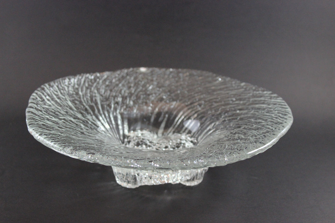 Clear glass bowl with textured design on a dark background