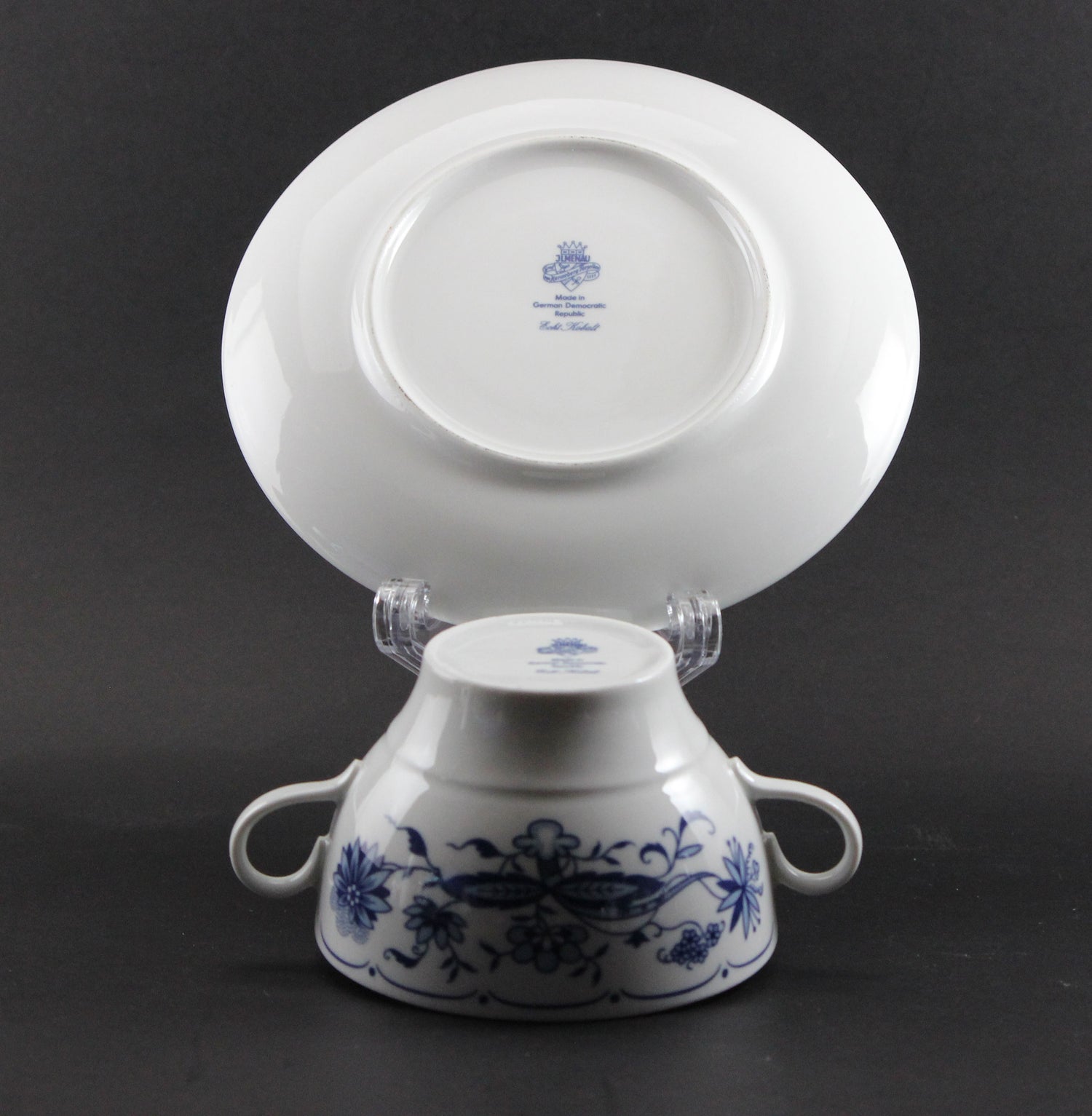 Set of white porcelain soup bowls with blue floral patterns on a gray background