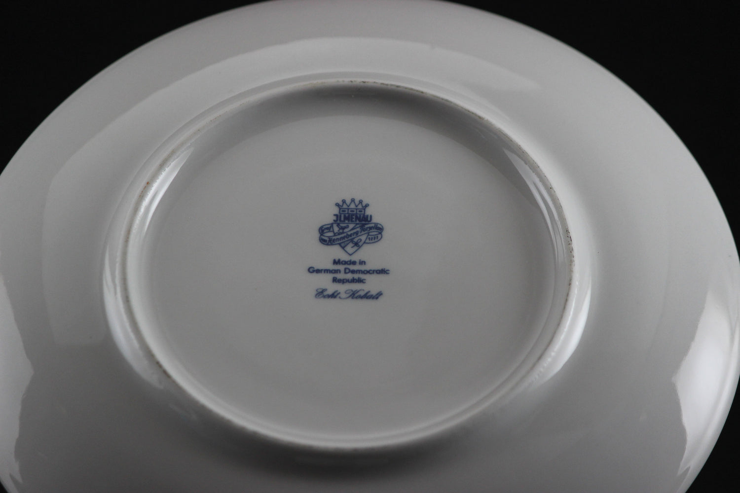 Set of white porcelain soup bowls with blue floral patterns on a gray background