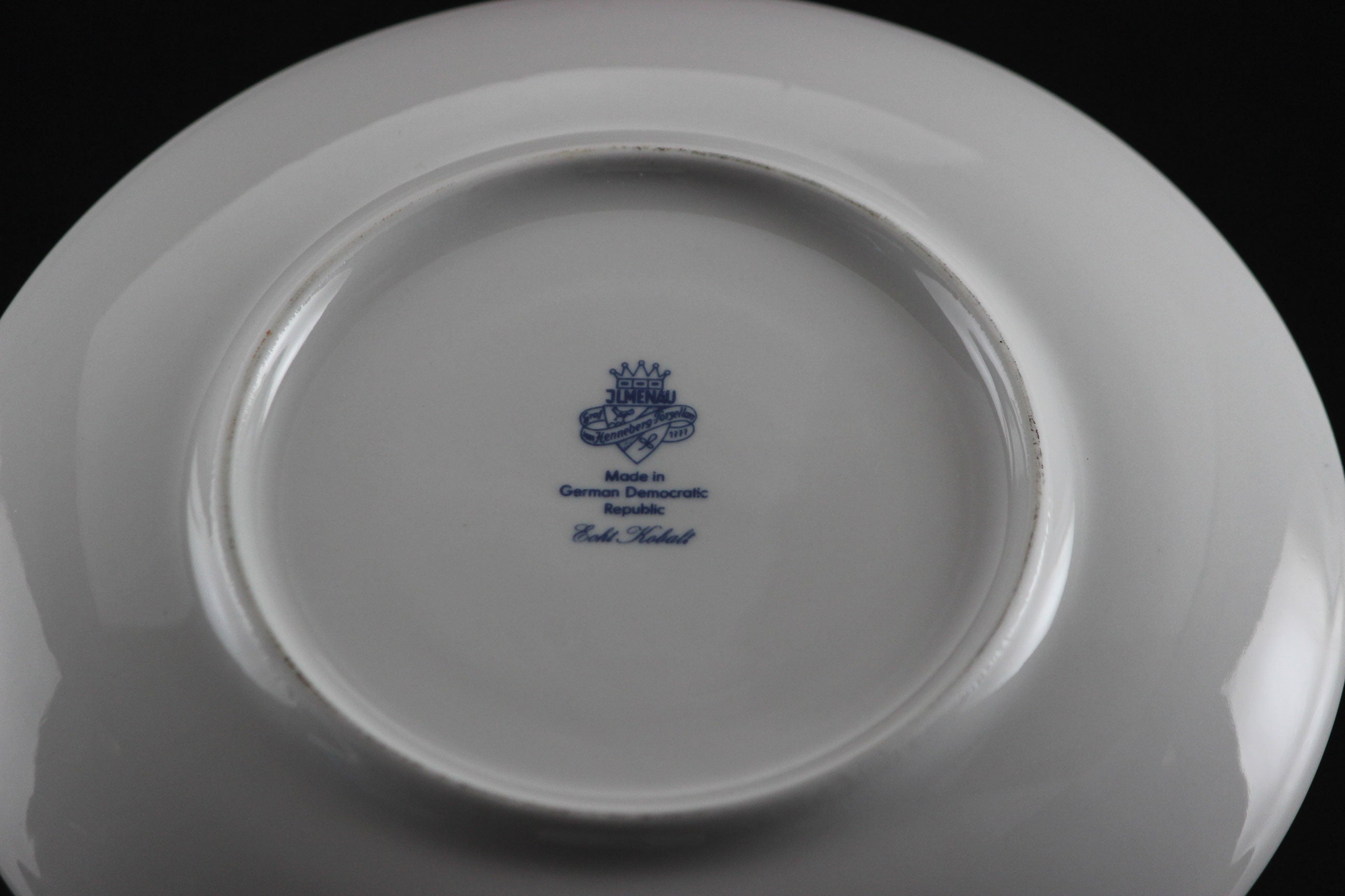 Set of white porcelain soup bowls with blue floral patterns on a gray background
