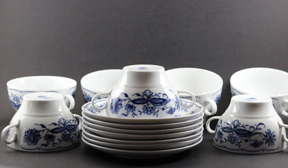 Set of white porcelain soup  bowls with blue floral patterns on a gray background