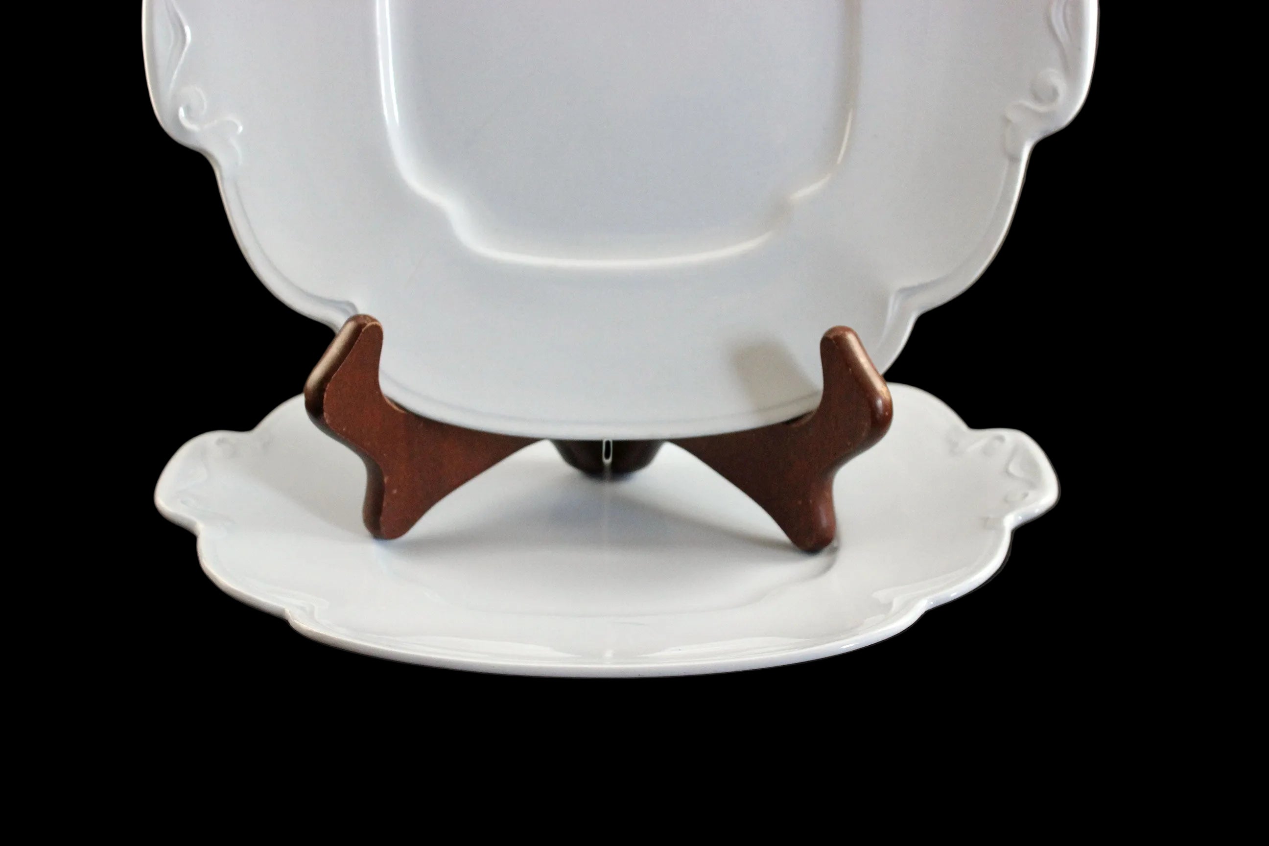 Light blue ceramic cake plate on black background.