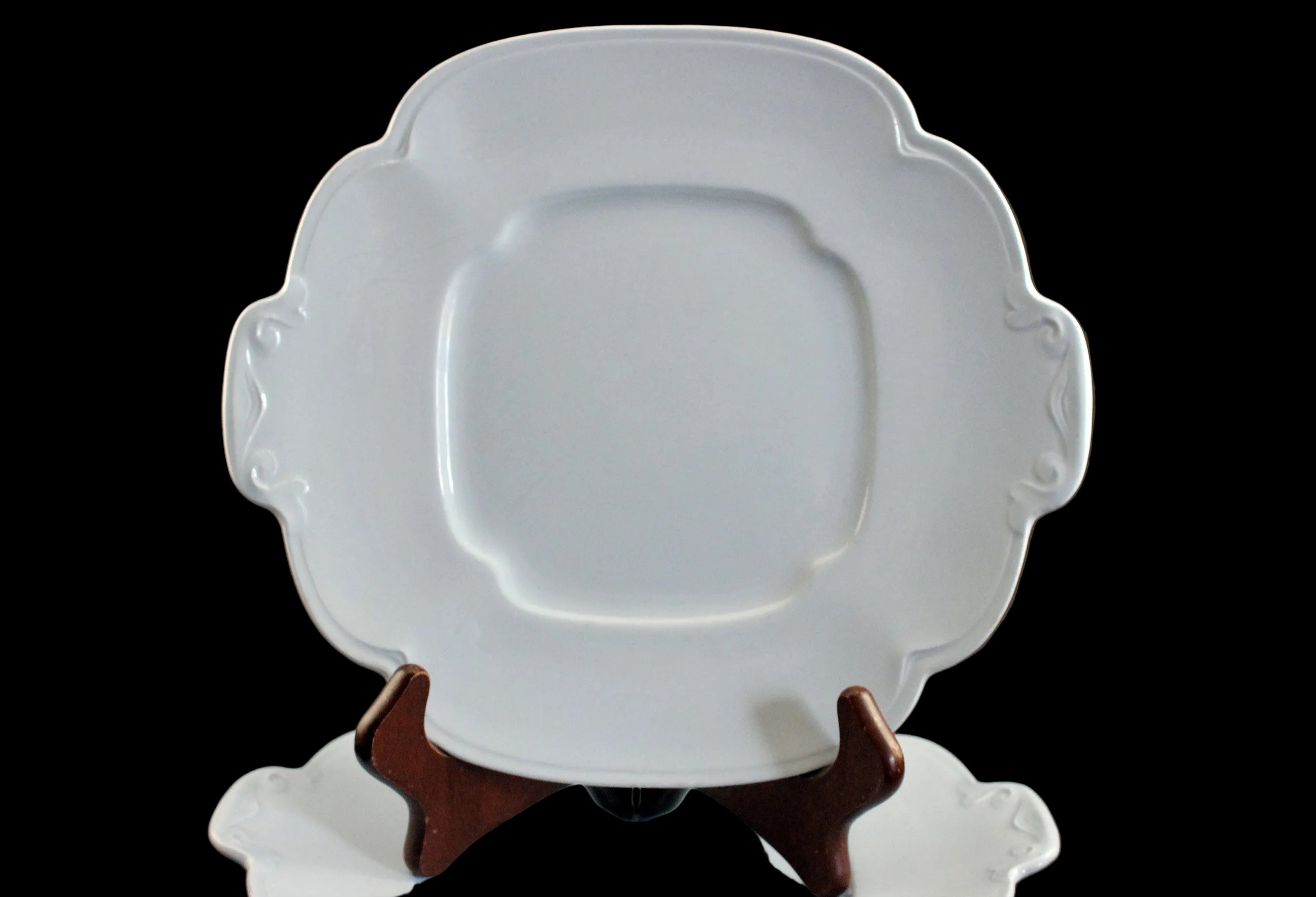 Light blue ceramic cake plate on black background.