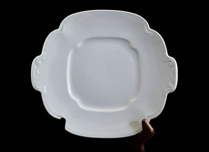 Light blue ceramic cake plate on black background.