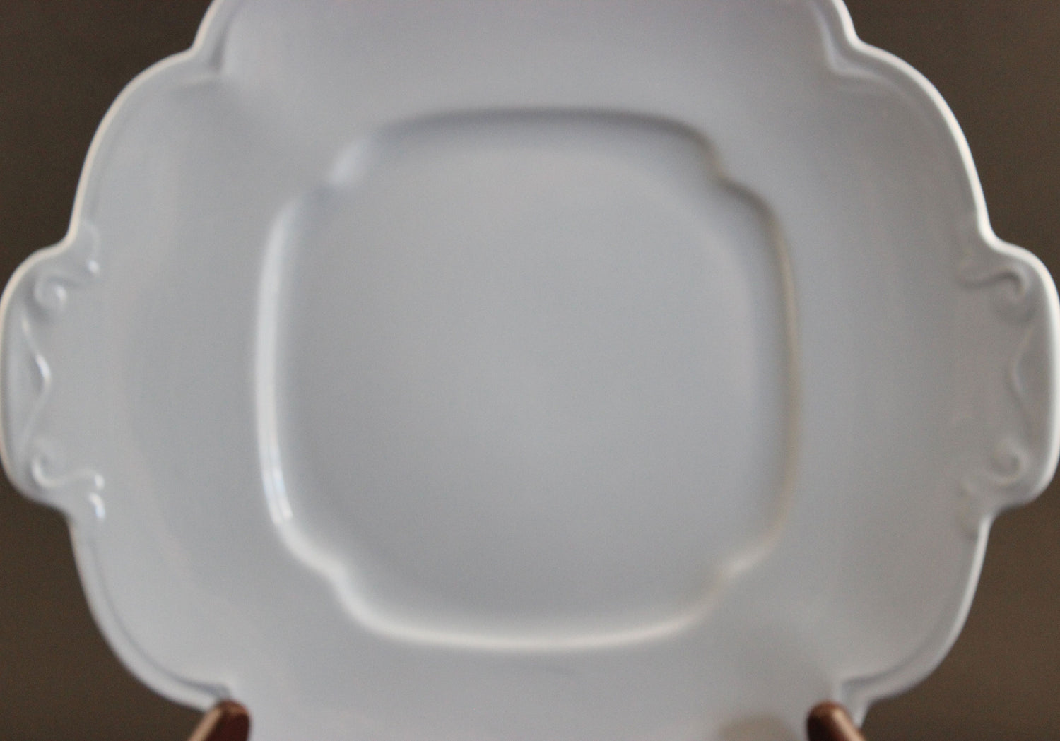 Light blue ceramic cake plate on black background.
