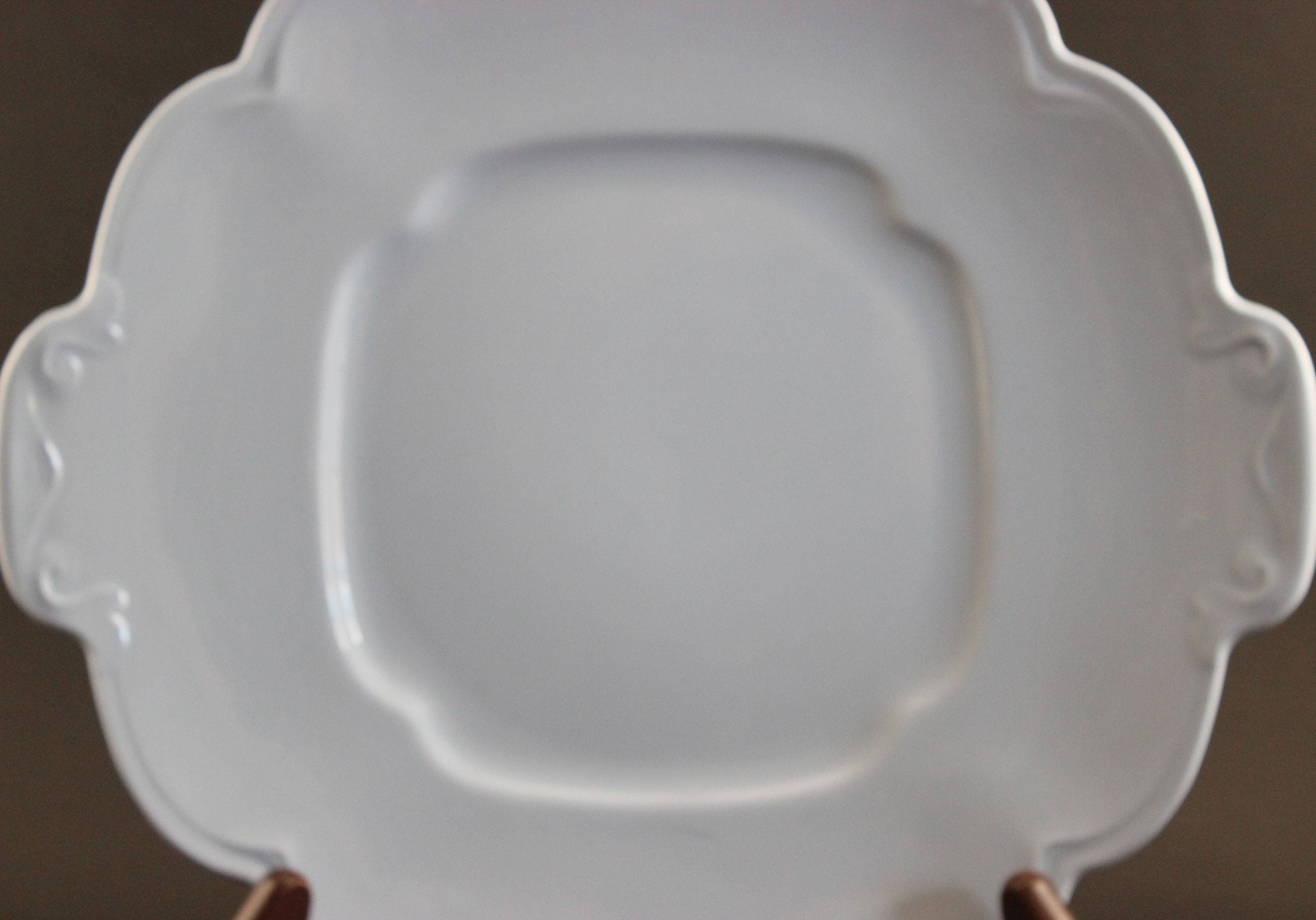Light blue ceramic cake plate on black background.