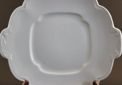Light blue ceramic cake plate on black background.