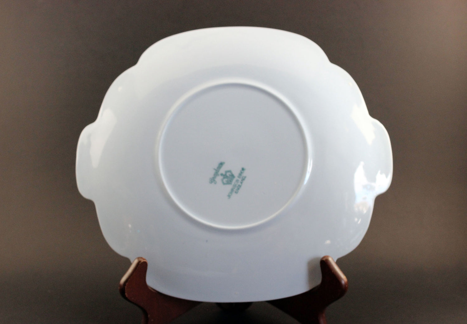 Light blue ceramic cake plate on black background.