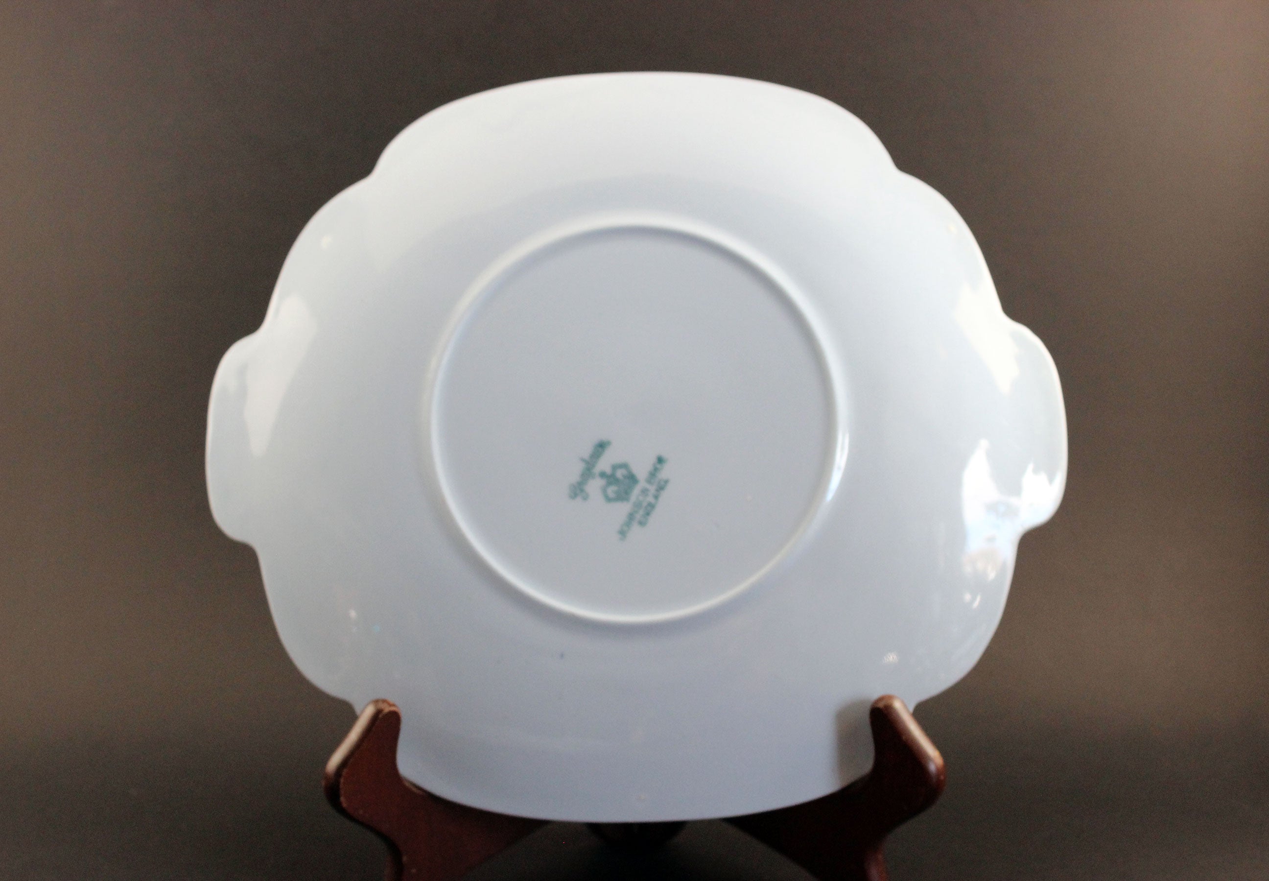 Light blue ceramic cake plate on black background.