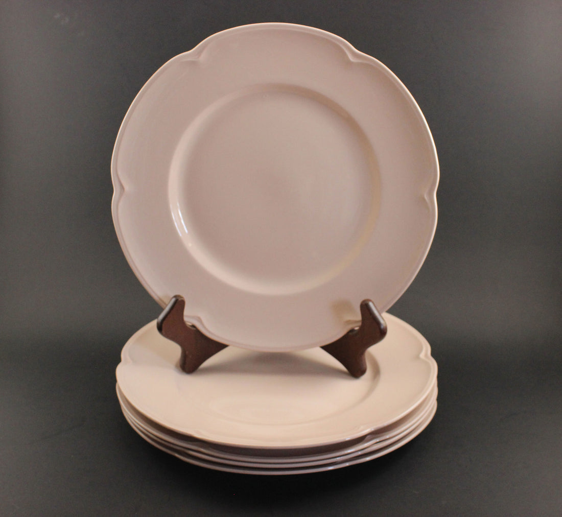 Set of pink ceramic petalware plates on a dark gray background