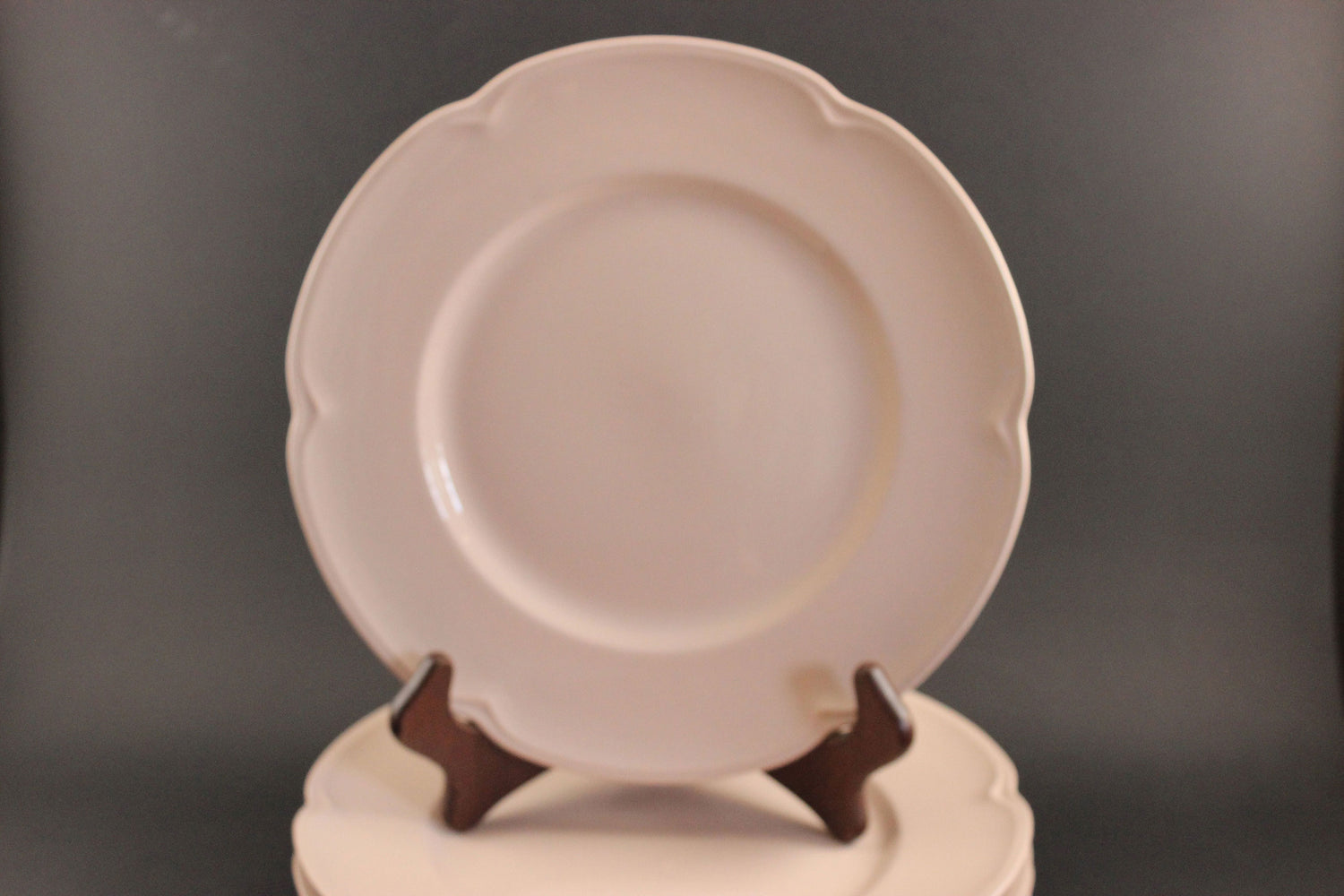 Pink ceramic petalware plate on a dark gray background