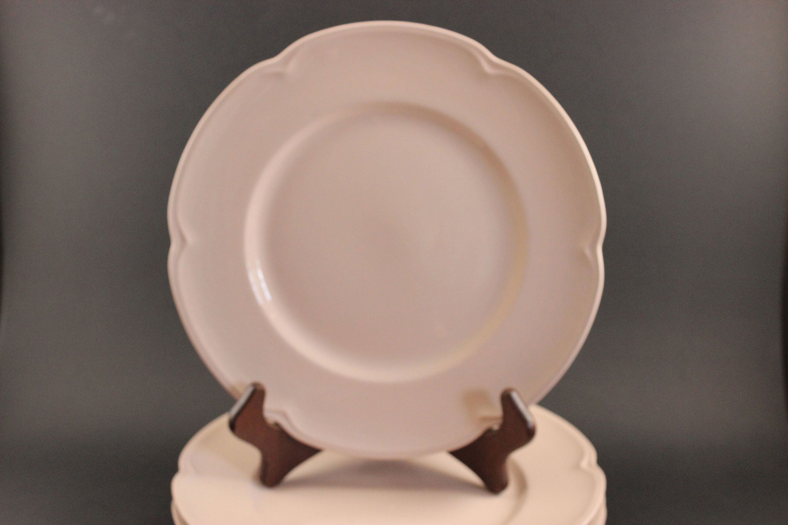 Pink ceramic petalware plate on a dark gray background