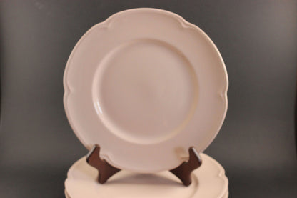 Pink ceramic petalware plate on a dark gray background