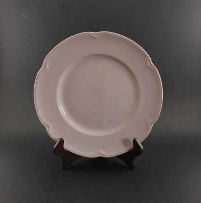 Pink ceramic petalware plate on a dark gray background