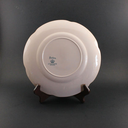 Pink ceramic petalware plate on a dark gray background