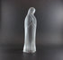 Clear glass statue of a standing figure on a dark background