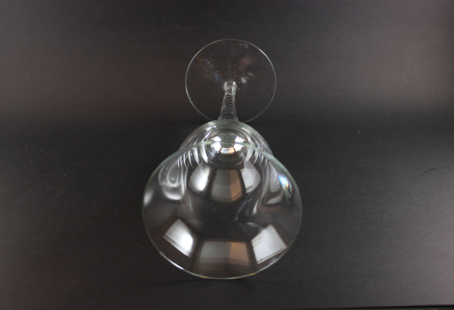 Clear glass wine glass on a black background